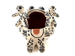 frog shaped storyteller in white with black paint