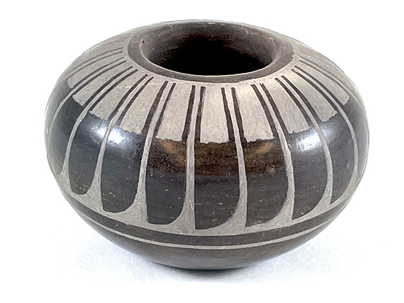 black pot with white etching geometric designs
