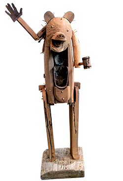 Wooden sculpture in the form a bear waving with one hand