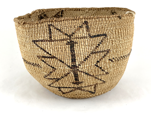 Woven basket with geometric patterns in brown on a natural, textured background.