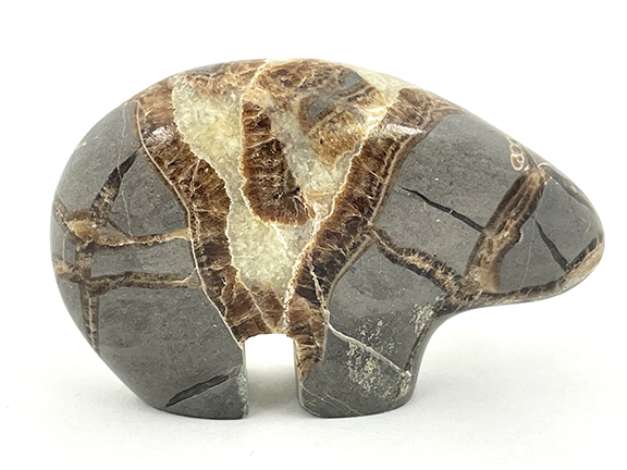 Carved stone bear figure with gray and brown patterns.