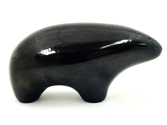 Shiny black ceramic figure resembling a stylized animal.