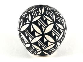 white jar with black geometric designs